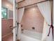 Bathroom with tub and shower, updated tile at 18 Winston Dr, Belleair, FL 33756