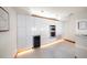 Sleek white kitchen featuring built-in appliances and wine cooler at 18 Winston Dr, Belleair, FL 33756