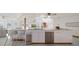 Modern kitchen with large island and breakfast bar seating at 18 Winston Dr, Belleair, FL 33756
