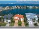 Waterfront home with terracotta roof and paved driveway at 18 Winston Dr, Belleair, FL 33756