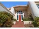 Brick pathway leads to red front door with large windows at 18 Winston Dr, Belleair, FL 33756