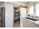 Well-organized pantry with sliding barn door and ample shelving at 18 Winston Dr, Belleair, FL 33756