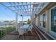 White pergola-covered patio with water views at 18 Winston Dr, Belleair, FL 33756