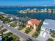 Waterfront home with terracotta roof and paved driveway at 18 Winston Dr, Belleair, FL 33756
