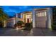 Beautiful two-story home with a red door at dusk at 18 Winston Dr, Belleair, FL 33756