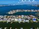 Wide aerial view of waterfront community, showcasing many homes and boats at 18 Winston Dr, Belleair, FL 33756