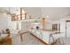 Open kitchen with white cabinetry and breakfast bar, overlooking living room at 18 Winston Dr, Belleair, FL 33756