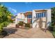 Two-story home with circular driveway and landscaping at 18 Winston Dr, Belleair, FL 33756