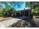 Cozy single story home featuring a front porch, screened-in back porch, and a concrete driveway at 2415 Durant Rd, Valrico, FL 33596