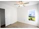 Bedroom with single door closet, ceiling fan and window at 25434 Colon Dr, Punta Gorda, FL 33983
