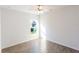 Bright bedroom with window, ceiling fan, and wood-look tile floor at 25434 Colon Dr, Punta Gorda, FL 33983