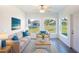 Bright sunroom with comfy seating and backyard views at 25434 Colon Dr, Punta Gorda, FL 33983
