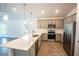 Modern kitchen with gray cabinets, quartz countertops, and stainless steel appliances at 25434 Colon Dr, Punta Gorda, FL 33983
