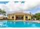 Community pool and clubhouse with ample space for relaxation at 2681 Whispering Pine Ln, North Port, FL 34287