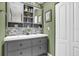 Double vanity bathroom with modern gray cabinets and updated fixtures at 2939 Yucca Ct, Palm Harbor, FL 34684