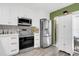 Modern kitchen with stainless steel appliances and white shaker cabinets at 2939 Yucca Ct, Palm Harbor, FL 34684