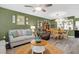 Bright living room features a comfy sofa and a dining area, perfect for entertaining at 2939 Yucca Ct, Palm Harbor, FL 34684