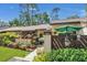 Charming home featuring beautiful landscaping, wood trim accents and a delightful umbrella-covered entry at 2939 Yucca Ct, Palm Harbor, FL 34684