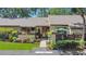 Charming home with a beautiful front yard featuring lush landscaping and a welcoming entrance at 2939 Yucca Ct, Palm Harbor, FL 34684