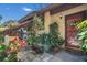 Charming front entrance with lush landscaping and red door at 2939 Yucca Ct, Palm Harbor, FL 34684