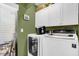 Laundry room with washer, dryer, and extra storage cabinets at 2939 Yucca Ct, Palm Harbor, FL 34684