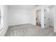 Spacious bedroom with gray carpeting and access to a bathroom at 29634 Fedora Cir, Brooksville, FL 34602