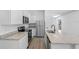 Modern kitchen with white cabinets, granite countertops, and stainless steel appliances at 29634 Fedora Cir, Brooksville, FL 34602