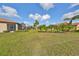 Landscaped backyard with lush grass and palm trees at 377 Cedar Falls Dr, Apollo Beach, FL 33572