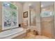 Main bathroom with soaking tub, walk-in shower and double vanity at 4907 Londonderry Dr, Tampa, FL 33647