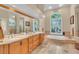 Main bathroom with double vanity and a large soaking tub at 4907 Londonderry Dr, Tampa, FL 33647