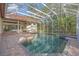 Spacious pool area with covered patio and lush landscaping at 4907 Londonderry Dr, Tampa, FL 33647