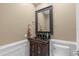 Elegant powder room with dark vanity and a large mirror at 4907 Londonderry Dr, Tampa, FL 33647