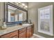 Bathroom with a large vanity and a window with plantation shutters at 4907 Londonderry Dr, Tampa, FL 33647