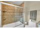 Bathroom with a shower/tub combination and built-in shelving at 4907 Londonderry Dr, Tampa, FL 33647