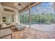 Covered patio overlooking refreshing pool; comfortable seating area at 4907 Londonderry Dr, Tampa, FL 33647