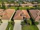 Aerial view of a well-maintained home with a clay tile roof and manicured landscaping at 5721 Sunset Falls Dr, Apollo Beach, FL 33572