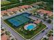 An aerial view showcases a community pool, tennis courts, and well-maintained properties at 5721 Sunset Falls Dr, Apollo Beach, FL 33572