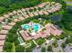 Aerial view of community clubhouse, pool, and surrounding neighborhood in a lush tropical setting at 5721 Sunset Falls Dr, Apollo Beach, FL 33572