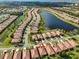 An aerial view of a neighborhood with ponds and single Gathering homes with tile roofs in a planned community at 5721 Sunset Falls Dr, Apollo Beach, FL 33572