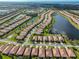 Aerial view showcases community homes and streets, surrounded by lush green landscaping and serene waterways at 5721 Sunset Falls Dr, Apollo Beach, FL 33572