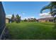 Large backyard surrounded by well-maintained properties and mature trees at 5721 Sunset Falls Dr, Apollo Beach, FL 33572