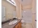 Cozy bathroom with a combined shower and tub, single sink, and flower decor at 5721 Sunset Falls Dr, Apollo Beach, FL 33572