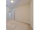 An empty bedroom shown with neutral walls, carpet, and an entrance into a hallway at 5721 Sunset Falls Dr, Apollo Beach, FL 33572