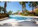 A beautiful community swimming pool with inviting blue umbrellas and lush landscaping surrounding the lounge area at 5721 Sunset Falls Dr, Apollo Beach, FL 33572