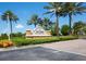 Del Webb Southshore Falls community sign with palm trees and landscaping on a sunny day at 5721 Sunset Falls Dr, Apollo Beach, FL 33572
