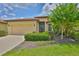 Beautiful single-Gathering home with a well-manicured lawn, mature landscaping, and attached two-car garage at 5721 Sunset Falls Dr, Apollo Beach, FL 33572