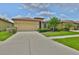 Charming single-story home featuring a well-manicured lawn and a classic tile roof at 5721 Sunset Falls Dr, Apollo Beach, FL 33572