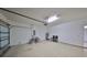 Spacious garage with bikes, extra seating, and a garage door at 5721 Sunset Falls Dr, Apollo Beach, FL 33572