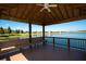 Charming gazebo overlooking a serene lake, perfect for relaxing and enjoying the beautiful water view at 5721 Sunset Falls Dr, Apollo Beach, FL 33572