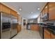 Spacious kitchen featuring stainless steel appliances, granite countertops, and wood cabinets at 5721 Sunset Falls Dr, Apollo Beach, FL 33572